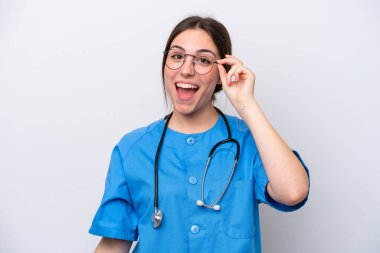 surgeon doctor woman holding tools isolated on white background with glasses and surprised