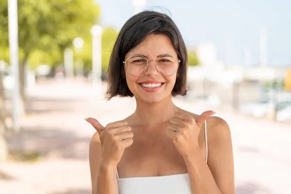 Young Pretty Bulgarian Woman Glasses Outdoors Thumbs Gesture Smiling — Stock Photo, Image