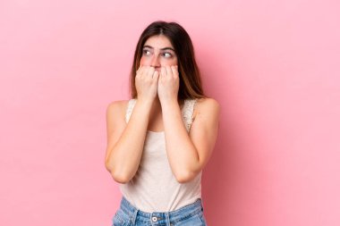 Pembe arka planda izole edilmiş beyaz bir kadın gergin ve korkmuş bir şekilde elleriyle suni teneffüs yapıyor.