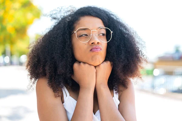 stock image Young African American woman at outdoors With glasses and tired