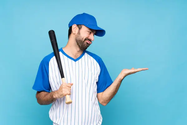 Young Man Playing Baseball Isolated Blue Background Holding Copyspace Doubts — Stock Photo, Image