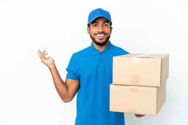 Delivery Ecuadorian man isolated on white background extending hands to the side for inviting to come