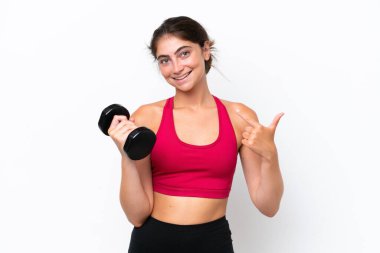 Young sport caucasian woman making weightlifting isolated on white background giving a thumbs up gesture