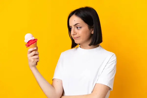 Young Caucasian Woman Cornet Ice Cream Isolated Yellow Background Sad — Stock Photo, Image