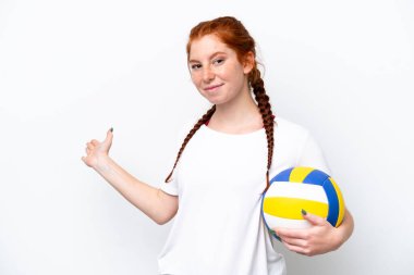 Young caucasian reddish woman playing volleyball isolated on white background extending hands to the side for inviting to come
