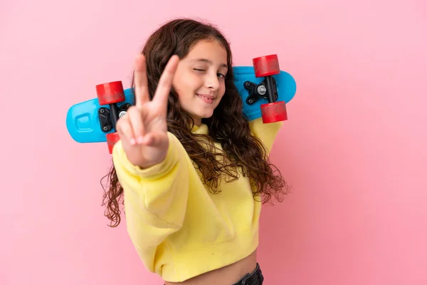 Little Caucasian Girl Isolated Pink Background Skate Doing Victory Gesture — Stock Photo, Image