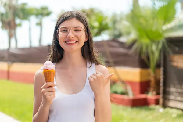 Young Pretty Ukrainian Woman Cornet Ice Cream Outdoors Pointing Side — Stock Photo, Image