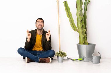 Bahçıvan içeride oturuyor. Parmakları çapraz ve en iyisini diliyor.