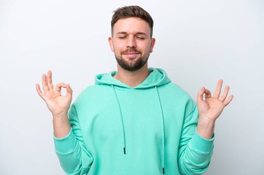 Beyaz arka planda Zen pozisyonunda beyaz tenli genç bir adam