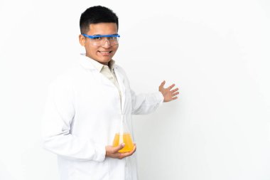 Young Ecuadorian scientific man extending hands to the side for inviting to come