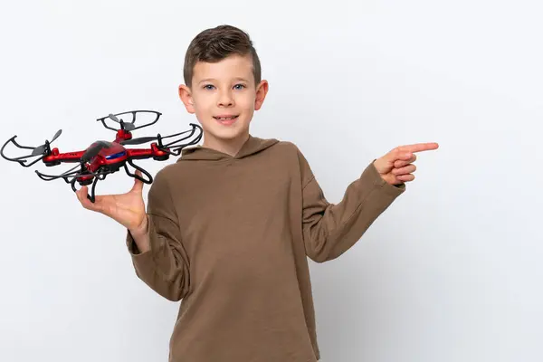 Little Caucasian Boy Holding Drone Isolated White Background Pointing Finger — Stock Photo, Image