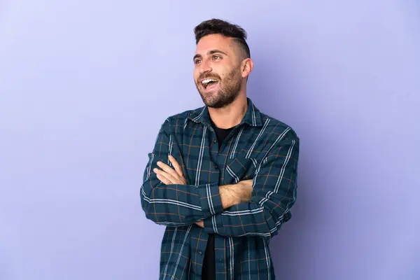 Caucasian man isolated on purple background happy and smiling
