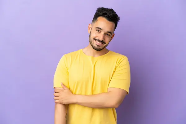 stock image Young caucasian man isolated on purple background laughing