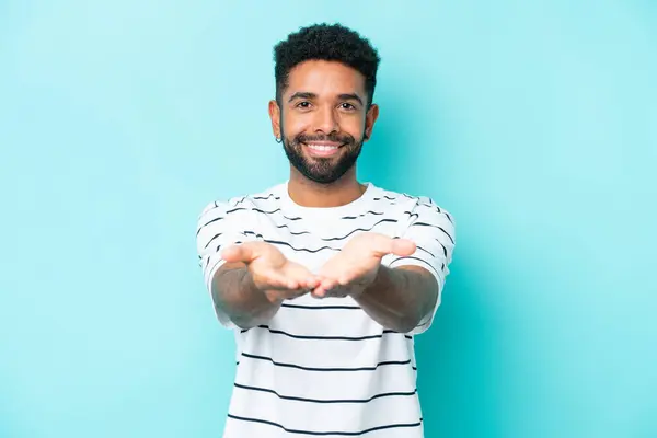 Young Brazilian Man Isolated Blue Background Holding Copyspace Imaginary Palm — Stock Photo, Image