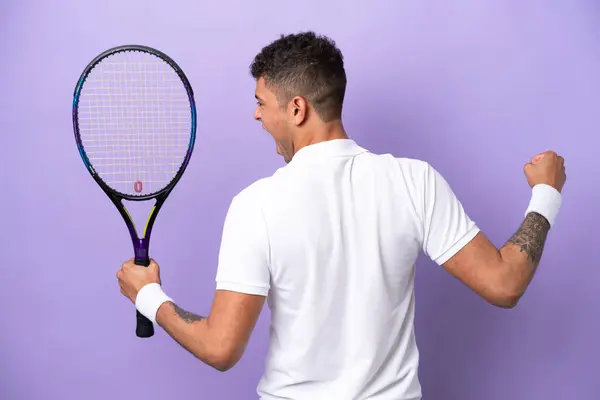 Young Brazilian Man Isolated Purple Background Playing Tennis Celebrating Victory — Fotografia de Stock