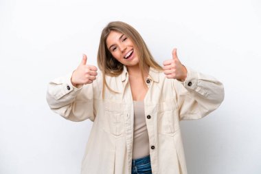 Young caucasian woman isolated on white bakcground giving a thumbs up gesture