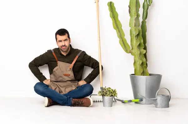 Gardener Man Sitting Floor Indoors Angry — Stock Photo, Image