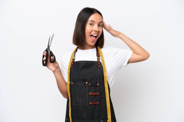Young seamstress woman isolated on white background with surprise expression