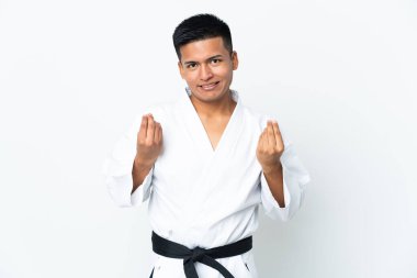 Genç Ekvadorlu adam beyaz arka planda karate yapıyor. Para hareketi yapıyor.