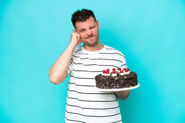 Young Caucasian Man Holding Birthday Cake Isolated Blue Background Frustrated — Stock Photo, Image