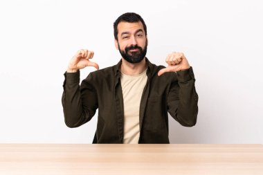 Masada sakallı beyaz bir adam gururlu ve kendini beğenmiş..