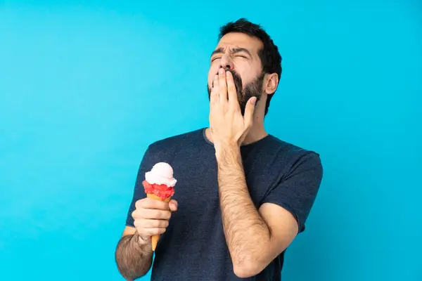 Young Man Cornet Ice Cream Isolated Blue Background Yawning Covering — Stock Photo, Image