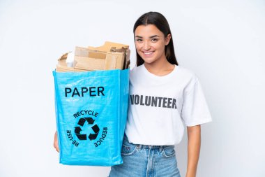 Young caucasian woman holding a recycling bag full of paper to recycle isolated on white background smiling a lot