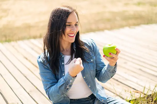 Middle Aged Woman Apple Outdoors Celebrating Victory Stock Photo