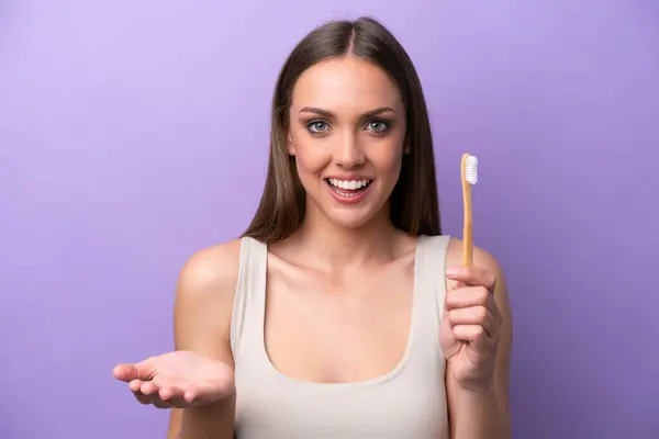 Young Caucasian Woman Brushing Teeth Isolated Purple Background Shocked Facial Stock Photo