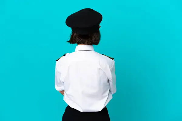 Young Airplane Pilot Isolated Blue Background Back Position ロイヤリティフリーのストック写真