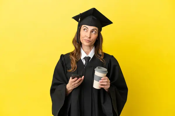 Middle Aged University Graduate Isolated Yellow Background Holding Coffee Take Стоковое Изображение