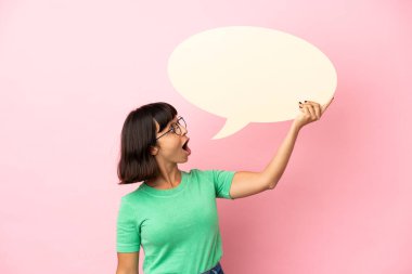 Youing woman holding an empty speech bubble