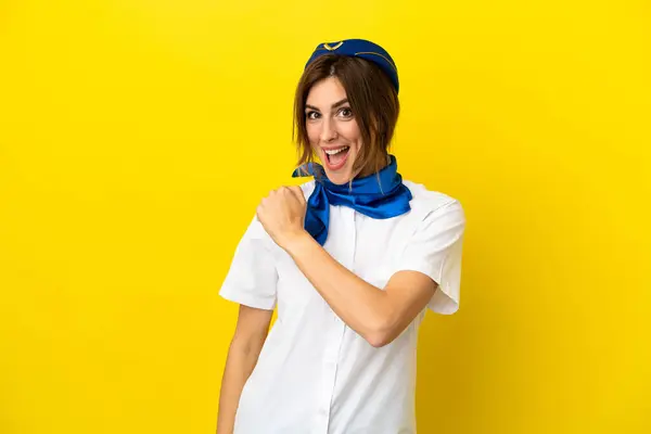 stock image Airplane stewardess woman isolated on yellow background celebrating a victory