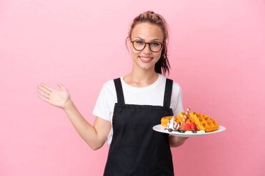 Pembe arka planda gözleme tutan Rus garson kız davet etmek için elini yana uzatıyor.