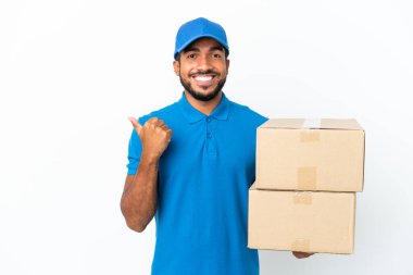Delivery Ecuadorian man isolated on white background pointing to the side to present a product