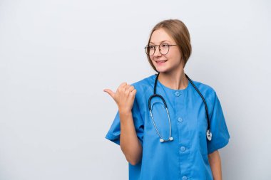 Young nurse doctor woman isolated on white background pointing to the side to present a product