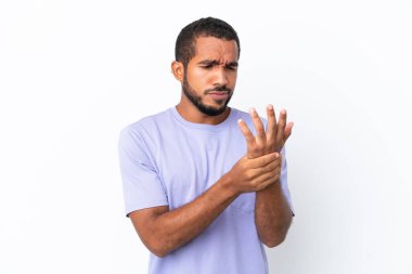 Young Ecuadorian man isolated on white background suffering from pain in hands