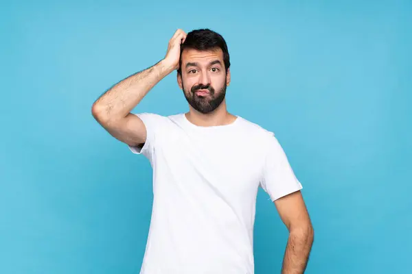 stock image Young man with beard  over isolated blue background with an expression of frustration and not understanding