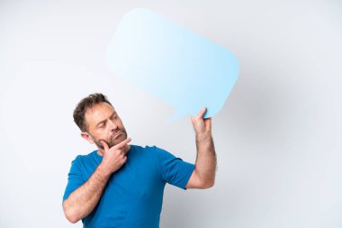 Middle age caucasian man isolated on white background holding an empty speech bubble and thinking