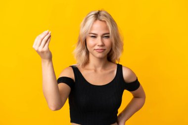 Young Russian woman isolated on yellow background making Italian gesture