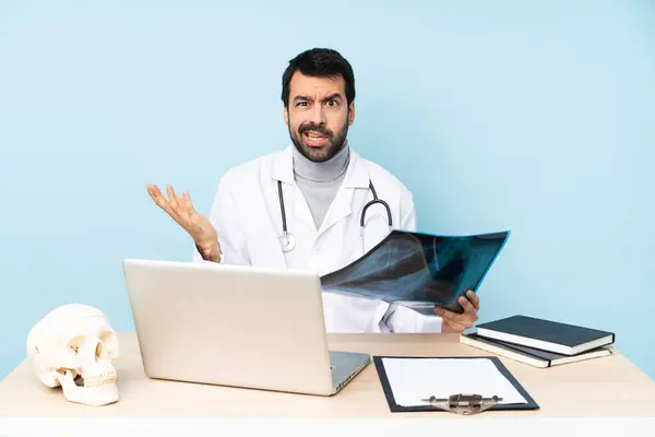stock image Professional traumatologist in workplace making doubts gesture