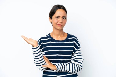 Young hispanic woman isolated on white background having doubts