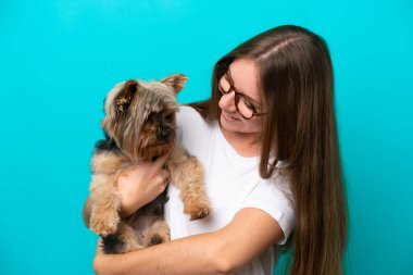 Mavi arka planda köpeği tutan Litvanyalı genç bir kadın.