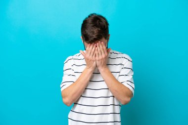 Young handsome Brazilian man isolated on blue background with tired and sick expression