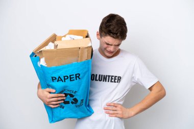 Beyaz arka planda izole edilmiş ve çaba sarf ettiği için sırt ağrısından muzdarip, geri dönüşüm için kağıt dolu bir çanta tutan genç Rus adam.