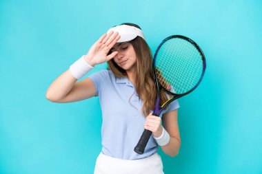 Young tennis player woman isolated on blue background making stop gesture and disappointed