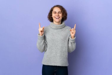 Young English woman isolated on purple background pointing up a great idea