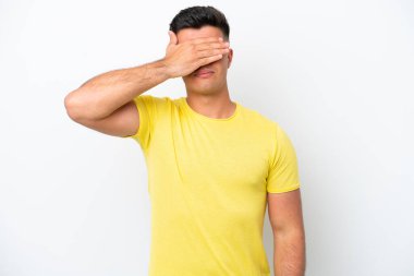 Young caucasian handsome man isolated on white background covering eyes by hands. Do not want to see something