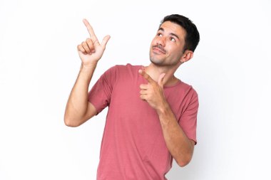 Young handsome man over isolated white background pointing with the index finger a great idea