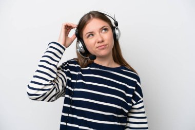 Tele pazarlamacı, beyaz arka planda izole edilmiş kulaklıkla çalışan beyaz bir kadın. Şüpheleri var ve kafası karışmış bir yüz ifadesi var.